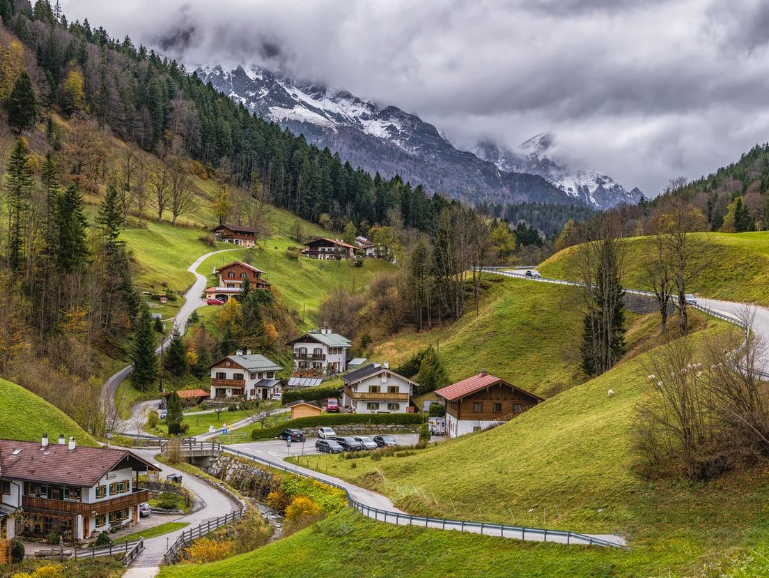 houses on green mountain surrounded with trees