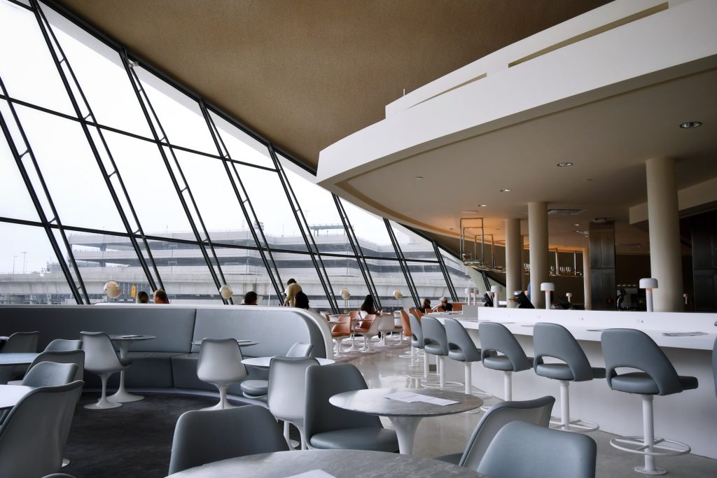 people sitting on white chairs inside building