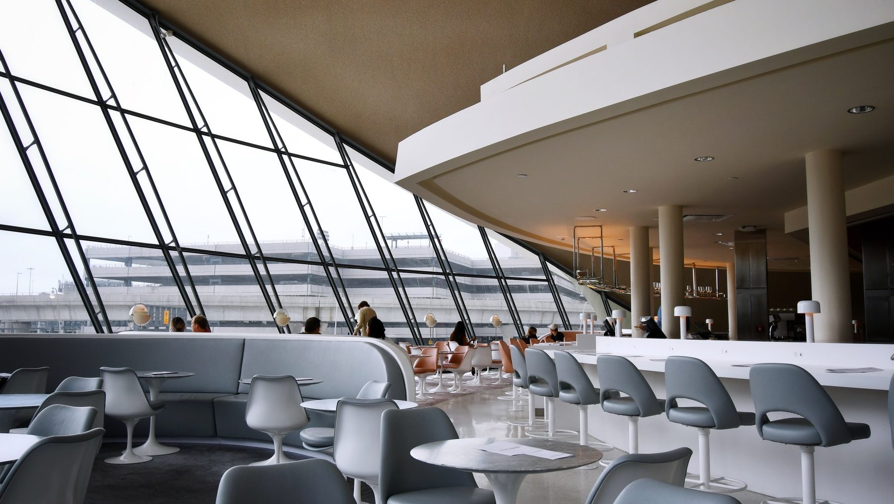 people sitting on white chairs inside building